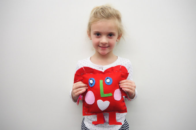 Kids sew a softie for kids in a shelter