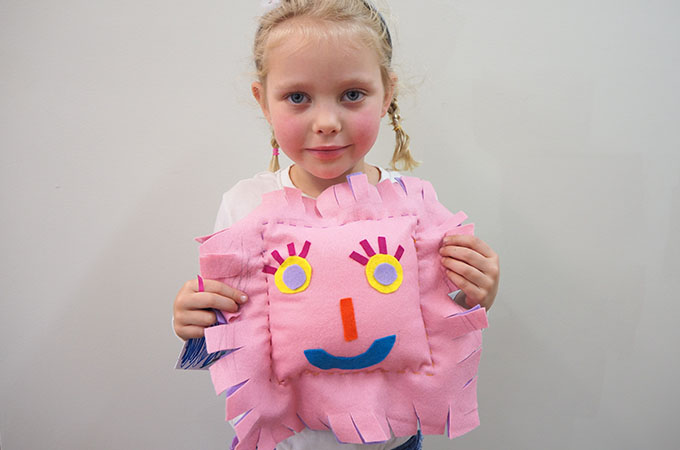 young girl with her hand sewn softie